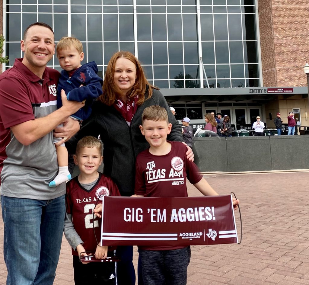 Author Cameron O'Connell stands with his family outside of Kyle Field football stadium at Texas A&M University.