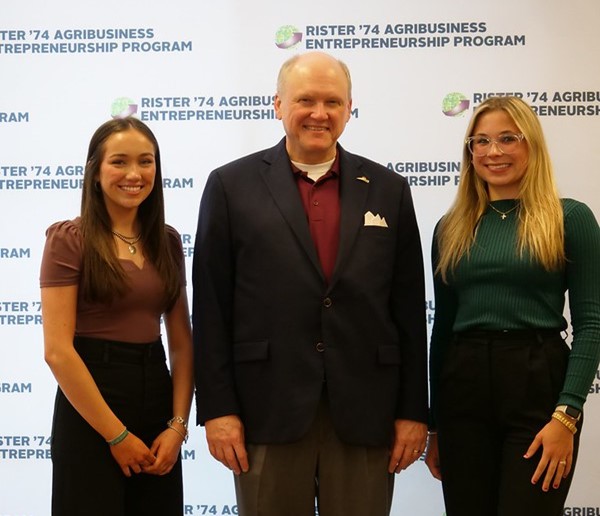 Emma Brett (left), an Animal Science major, and Harleigh Strack (right), an Agricultural Economics major, attend the in-person forum. Troy Thompson (center) is the lecturer for AGEC 324.