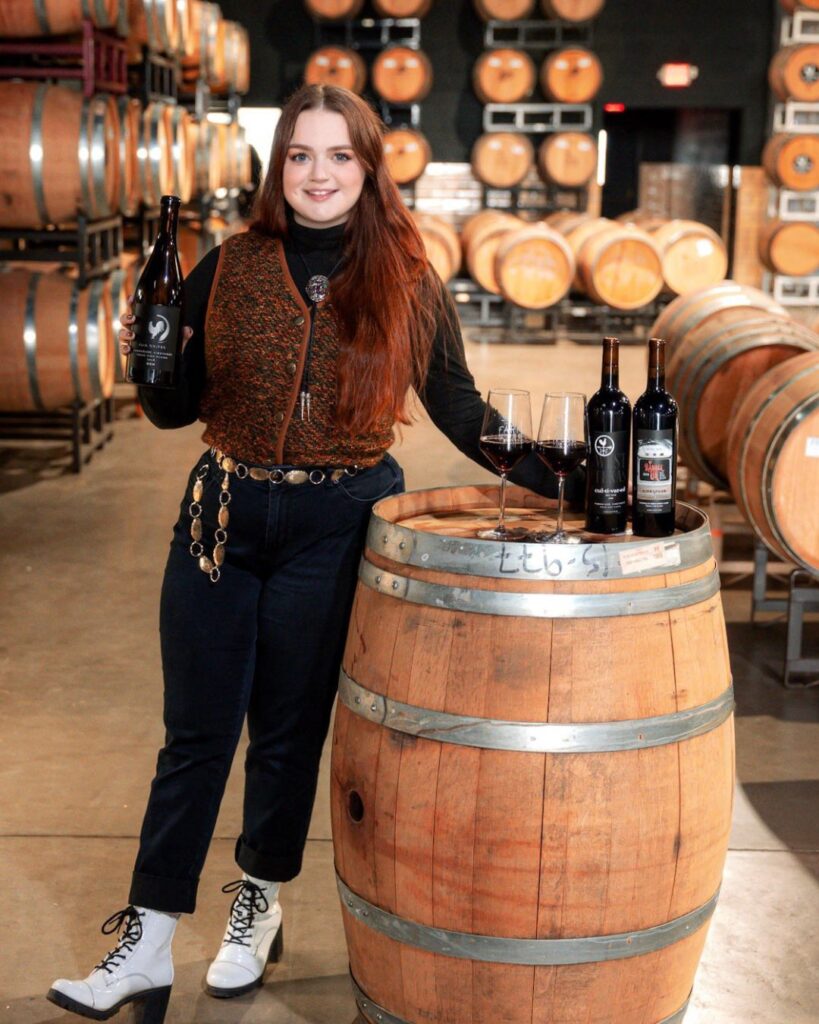 Madison Murchison holding a wine bottle