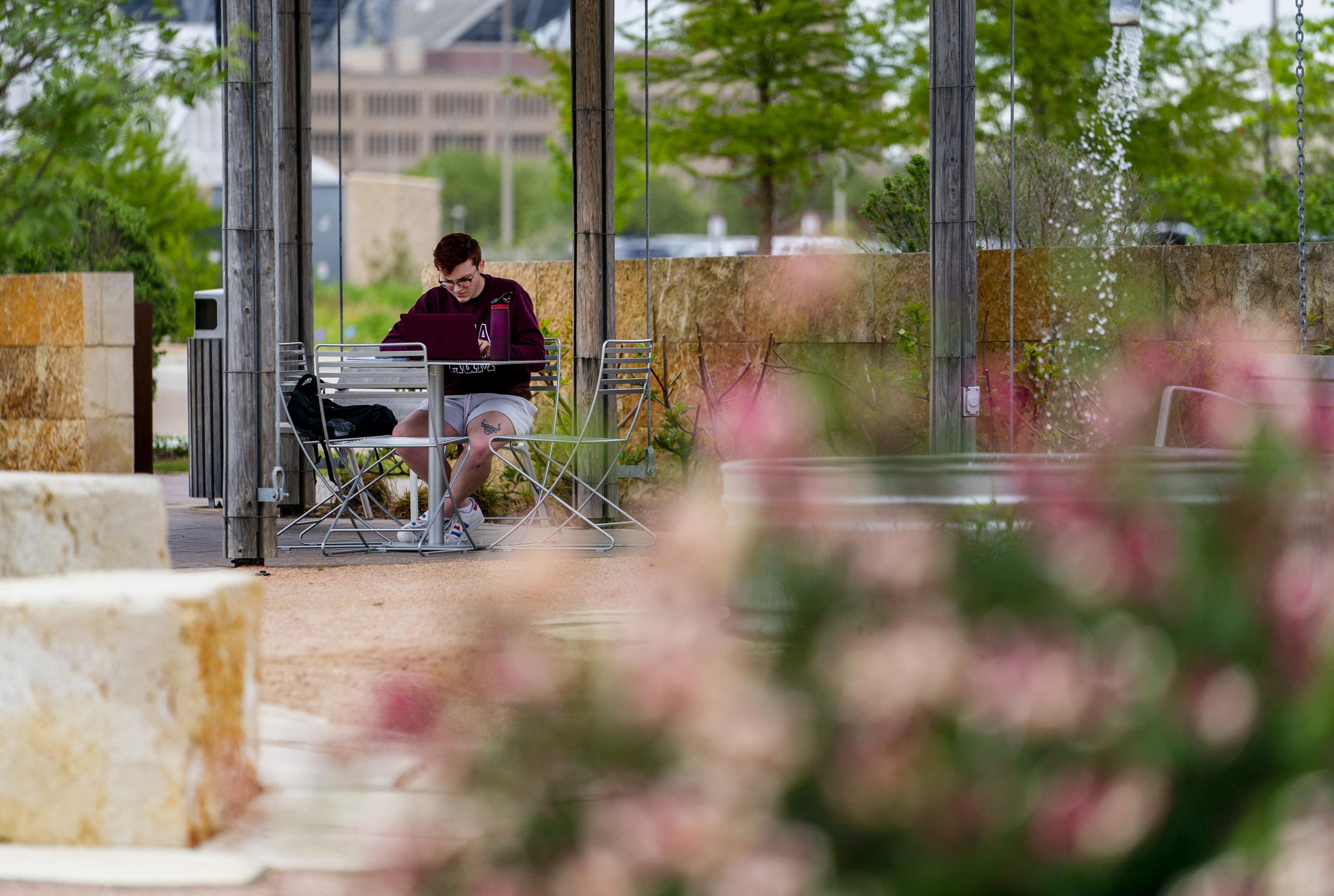 Student sitting at a table outside studying