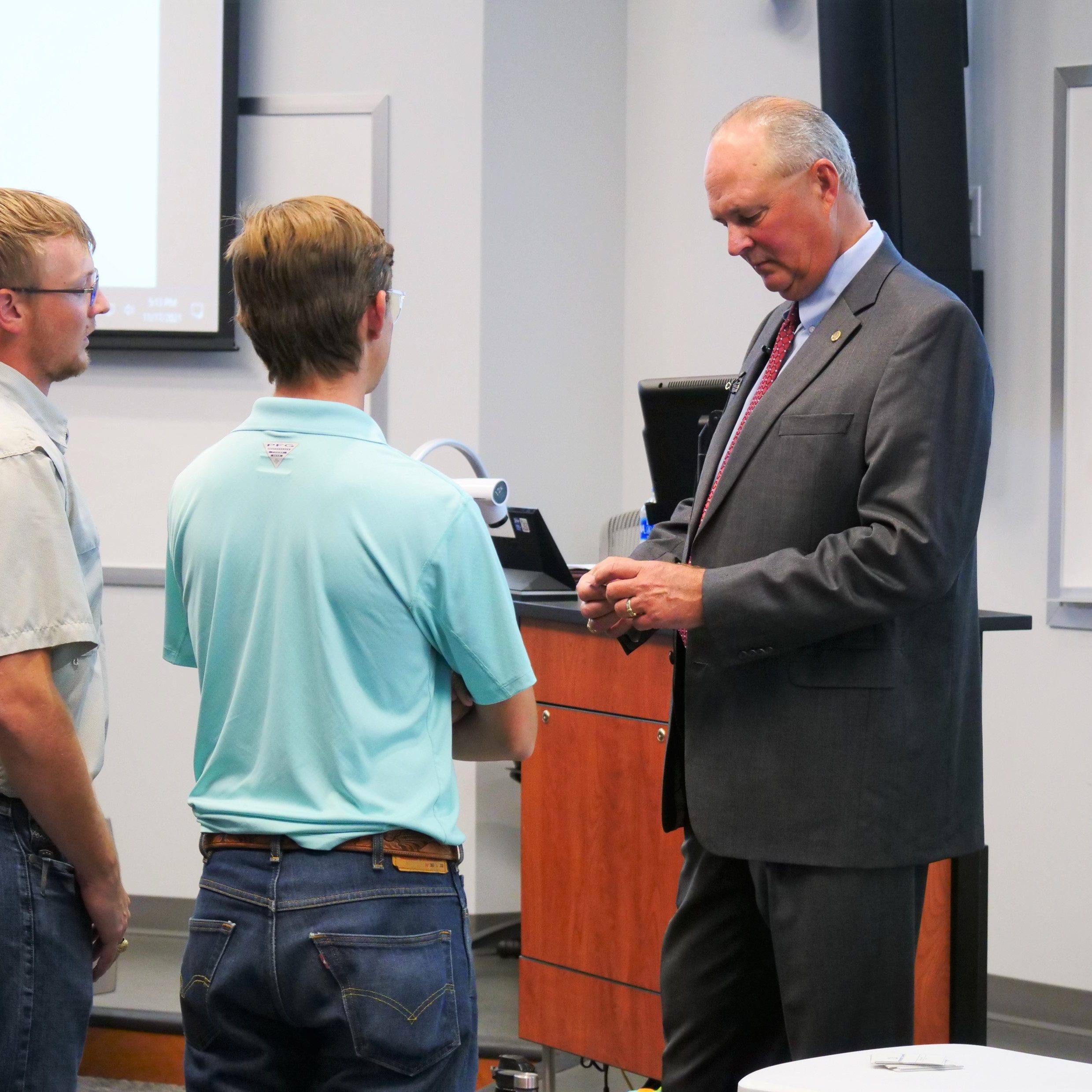 Professor talking to two students