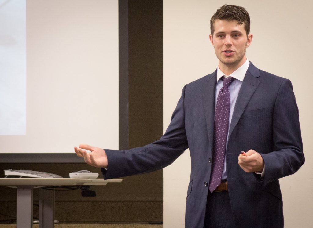 Man in professional attire giving a presentation