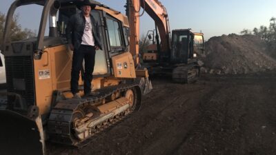 Benjamin Billings standing on heavy machinery