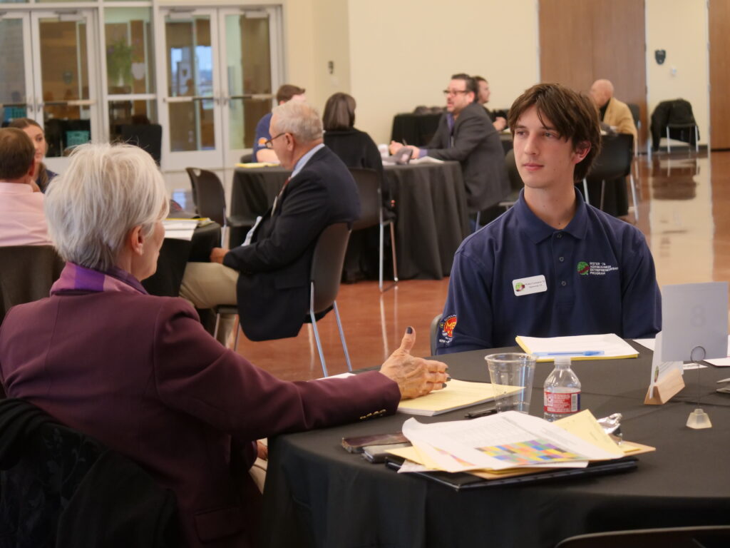 Walker Lenamon speaking to a mentor at a networking event